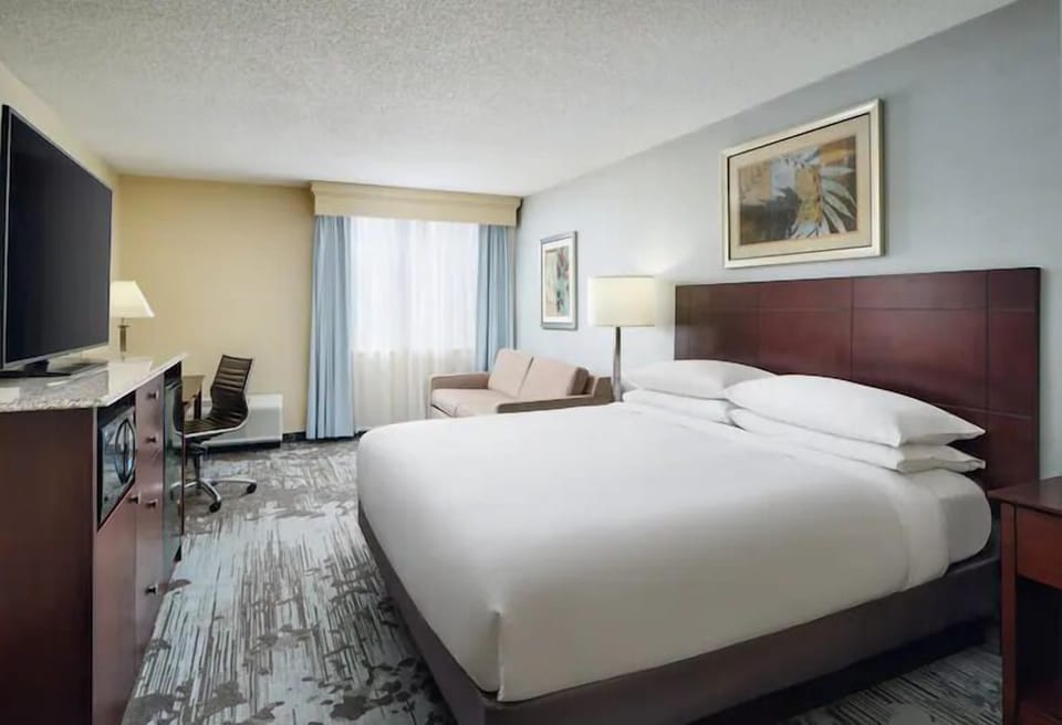 Unwind in a bright king room with cozy seating.