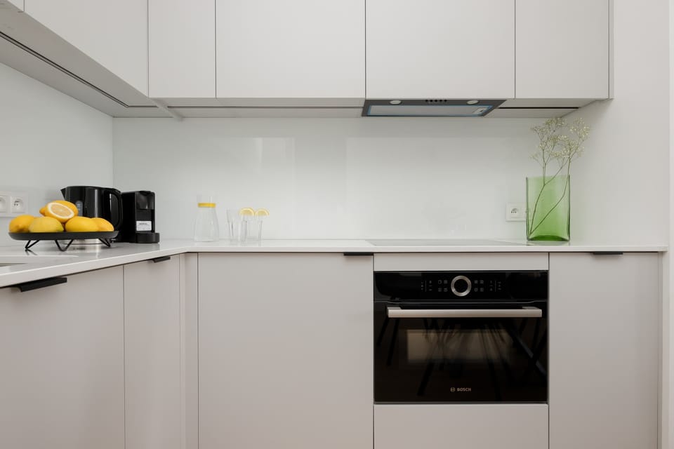 Modern kitchen with white cabinets and built-in appliances