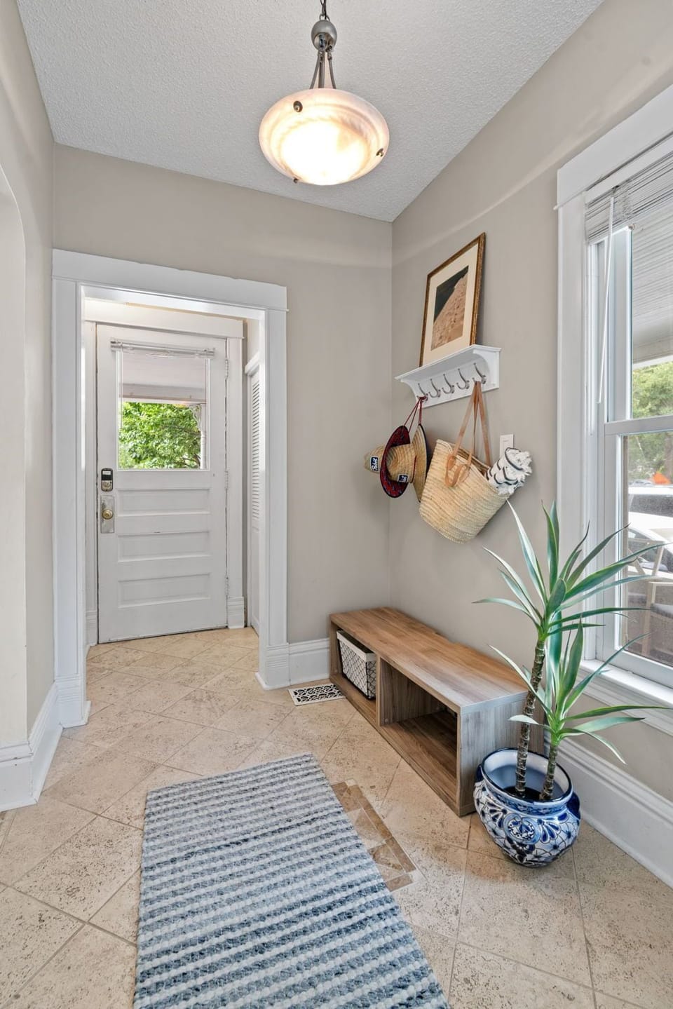 Step into your welcoming entrance where thoughtful touches like wall hooks and a cozy bench make arriving feel like coming home.