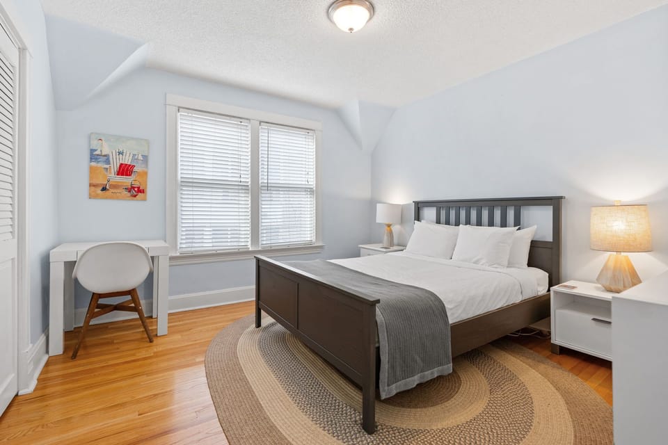 Drift off to sleep in your tranquil bedroom with soft blue walls and warm hardwood floors beneath your feet.