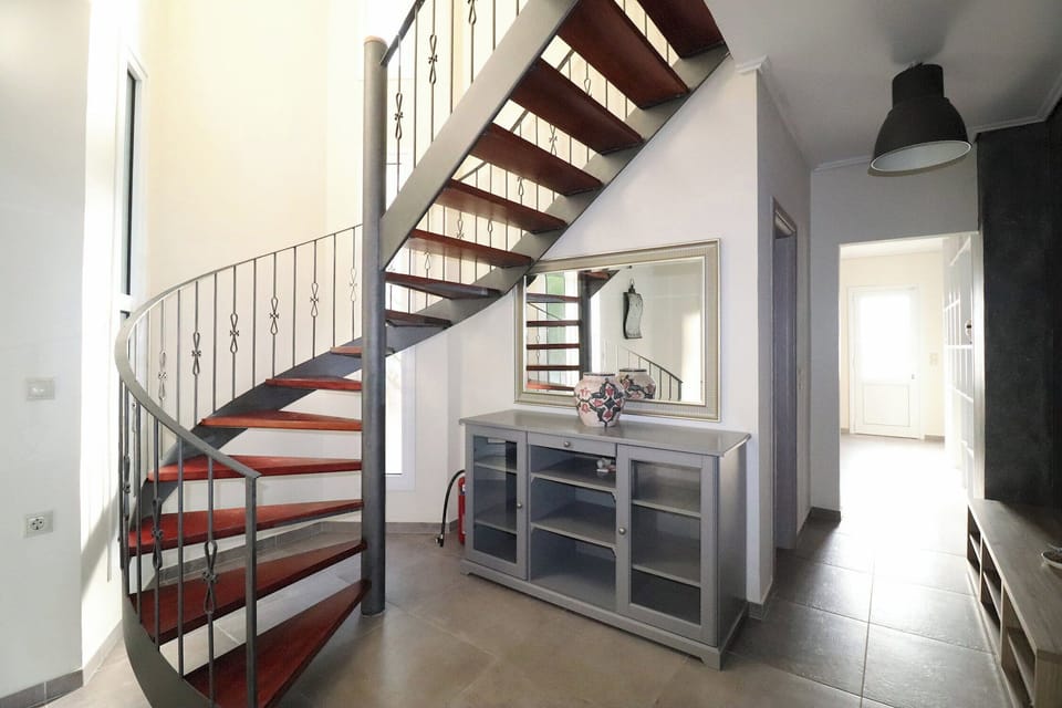 The spiral stairs to the upper floor bedrooms