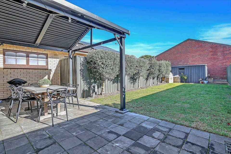 The pergola provides space for alfresco dining, no matter the weather.