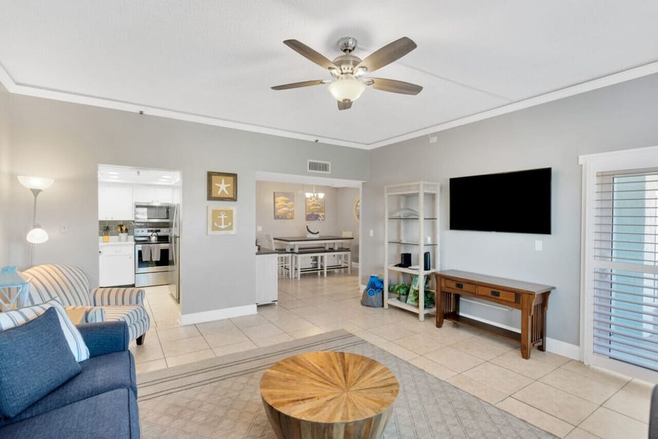 Spacious living room with Smart TV, and balcony access.