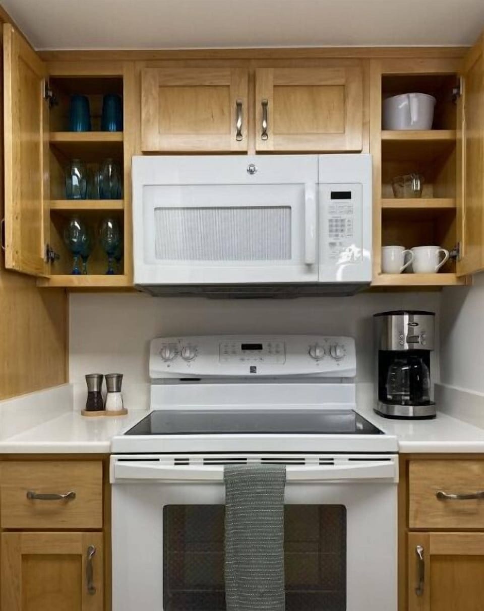 Equipped with dishes, drink ware, pots, pans, silverware, and cooking utensils.