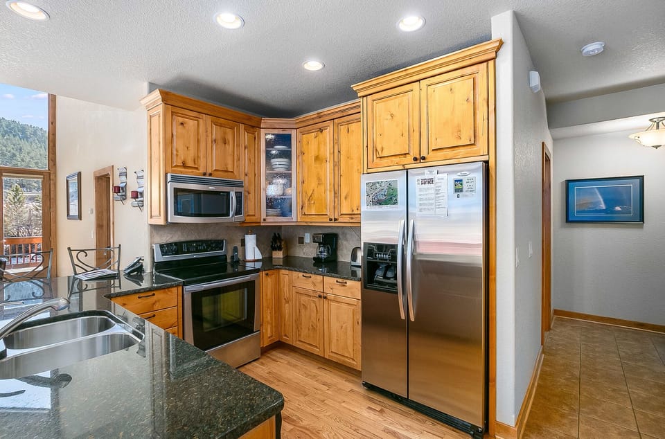 The kitchen area is open and inviting and stocked with cooking tools and appliances for making great meals.
