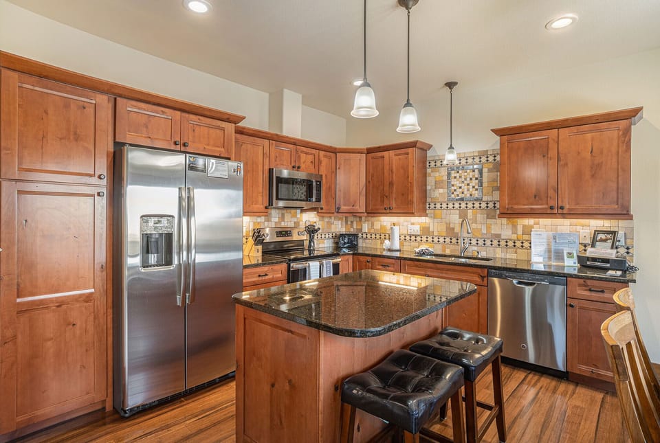 Island with 2 stools in this open kitchen
