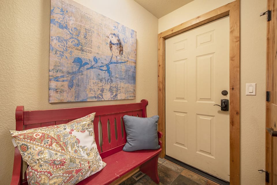 Fall River Retreat in Estes Park, Cute sitting area in the hallway. This door leads to the garage, not accessible to guests.