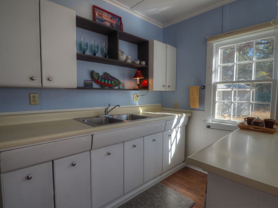 Plenty of drawer and counter space in the sunlit kitchen area.