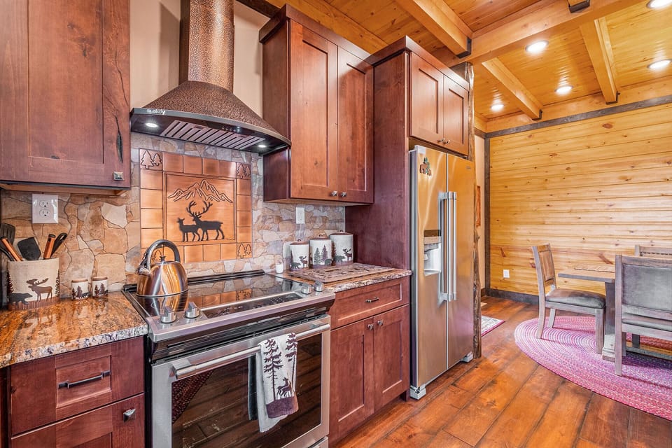 Hooded stove and full sized refrigerator.