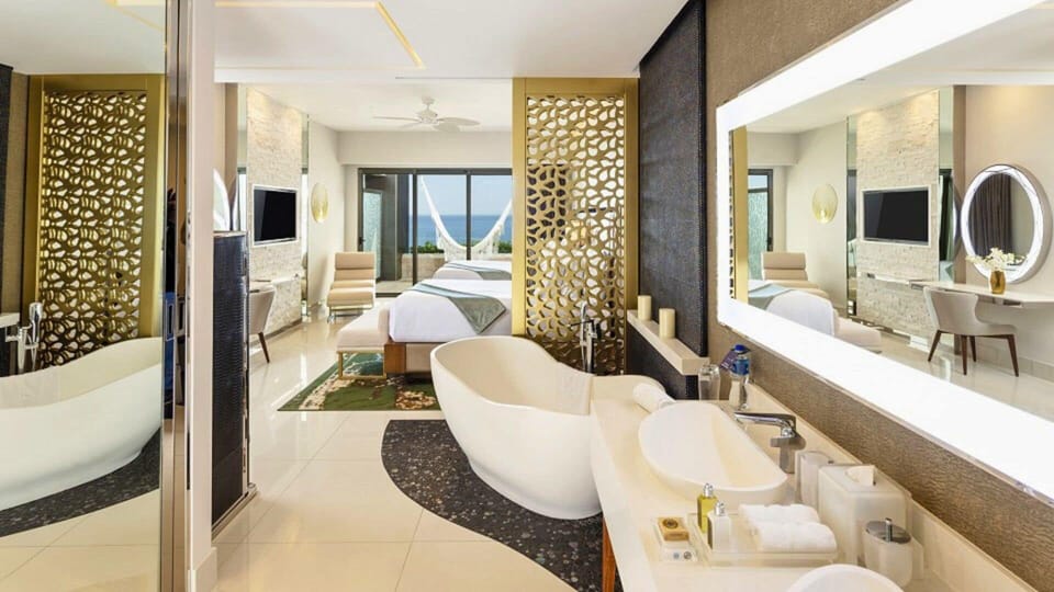 Luxury suite with soaking tub, ocean views, and elegant decor at Garza Blanca.
