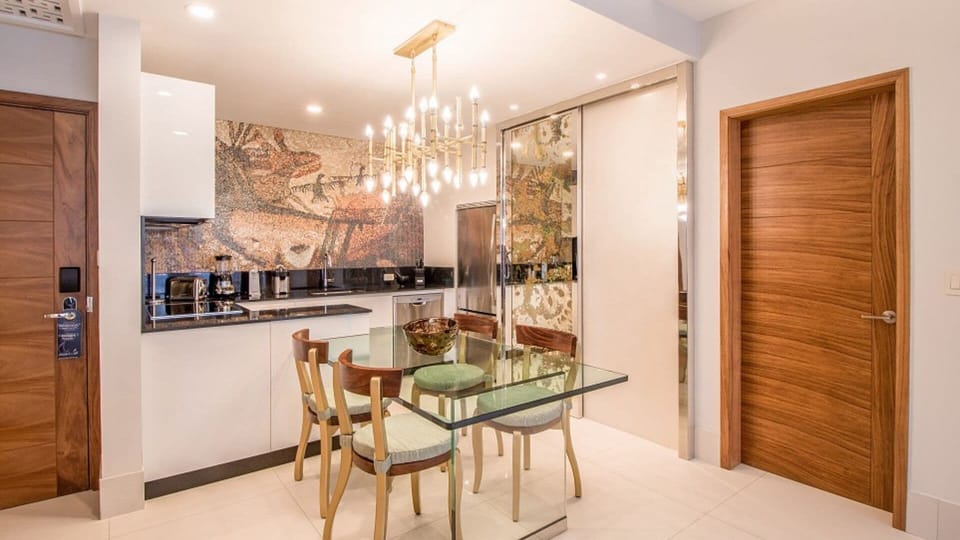 Modern kitchen with chic dining area and elegant lighting.