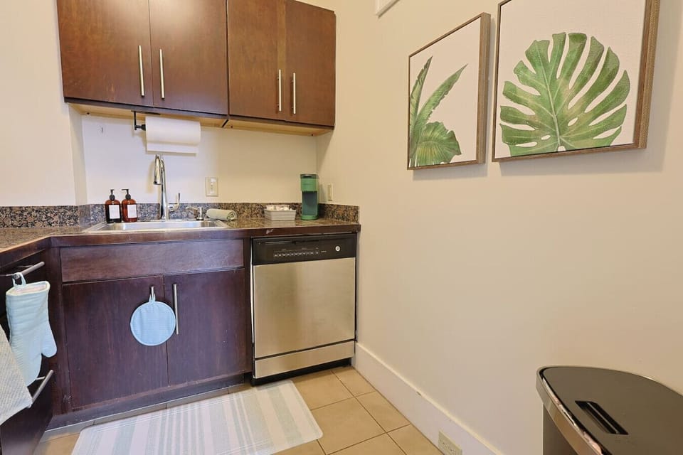 Kitchen: Whip up gourmet meals in a modern space adorned with vibrant tropical art!