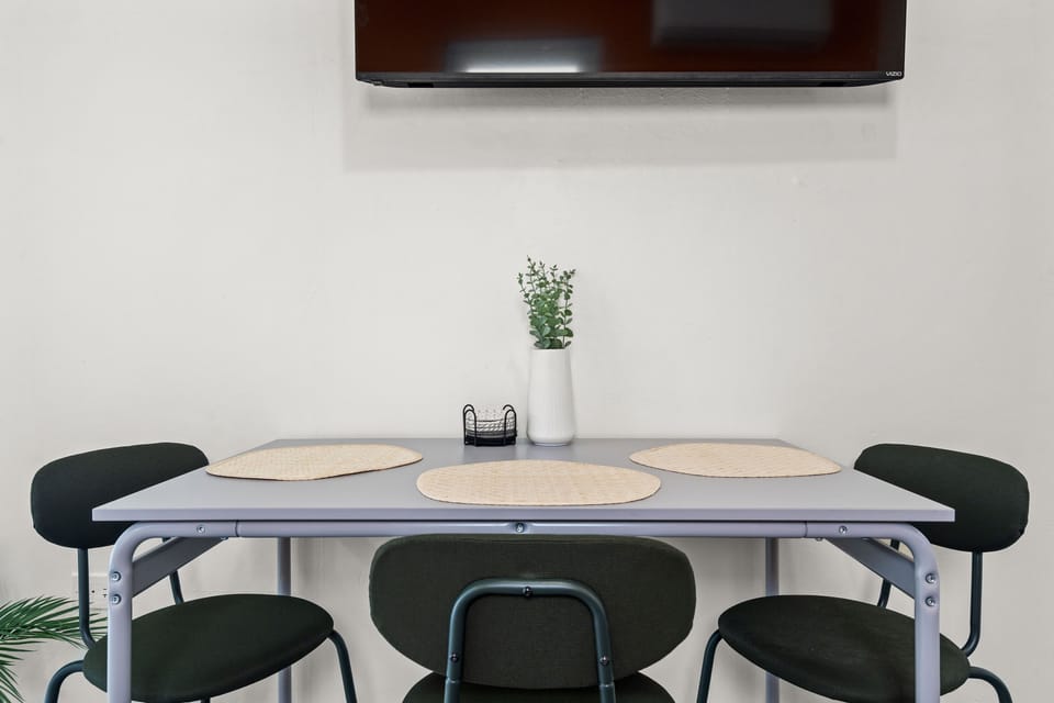 Charming dining area with a table for two and a decorative vase, perfect for intimate meals.