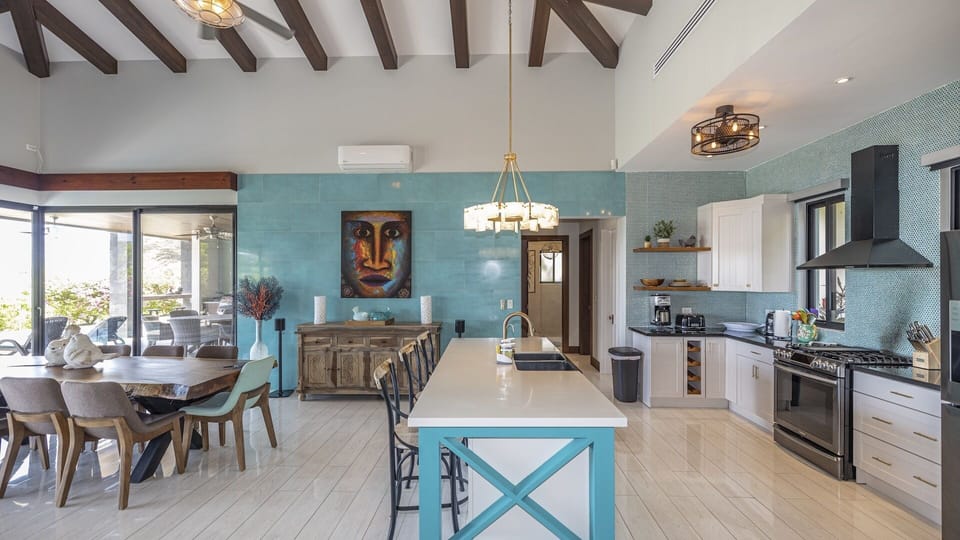 The tropical and stylish decor of the villa flows through the open concept interior living space.