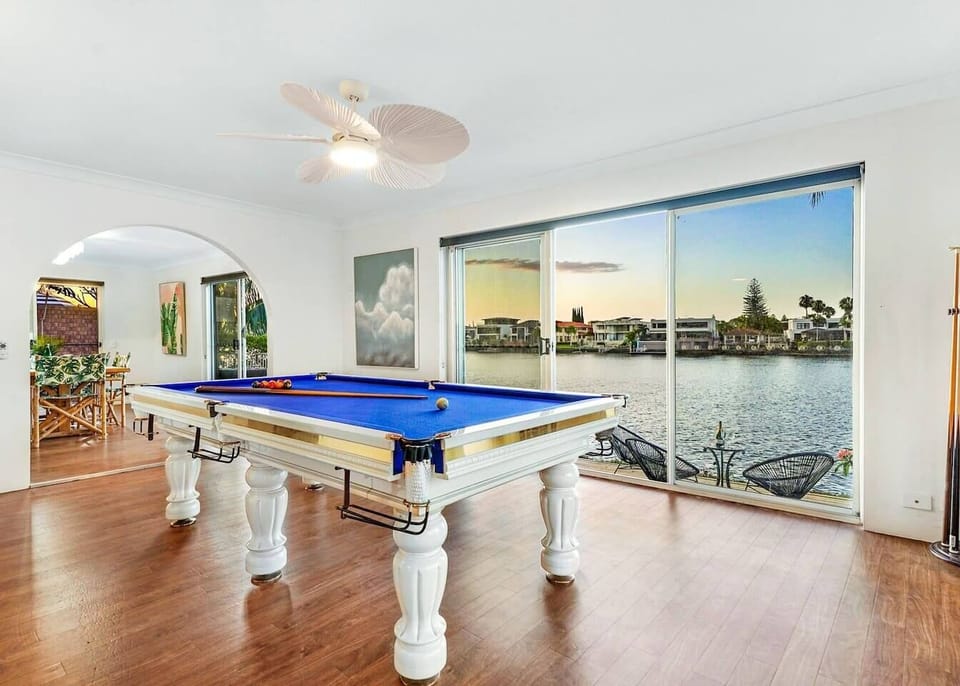 A pool table is ideal for relaxation or entertaining, with extensive glazing capturing stunning waterfront views from every angle. 
