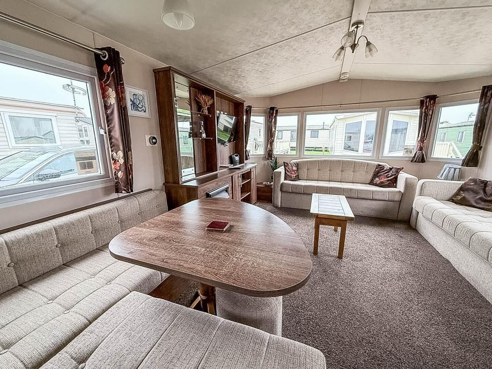 After a day at the beach, gather in the spacious living room of your caravan at California Cliffs Holiday Park