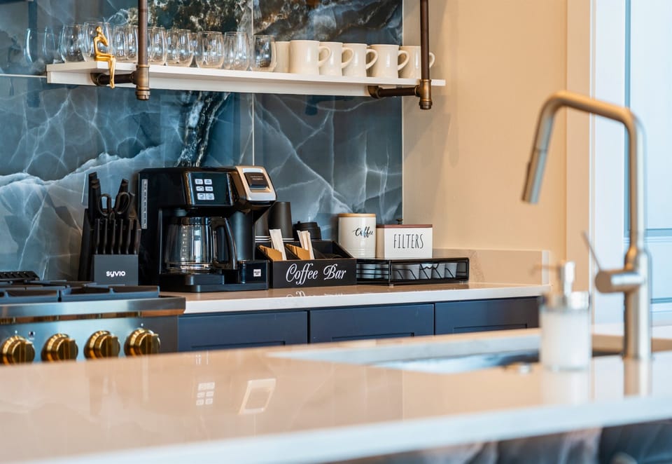 There is a Coffee Bar Set Up at the End of the Counter As Well with a Dual Style Coffee Maker