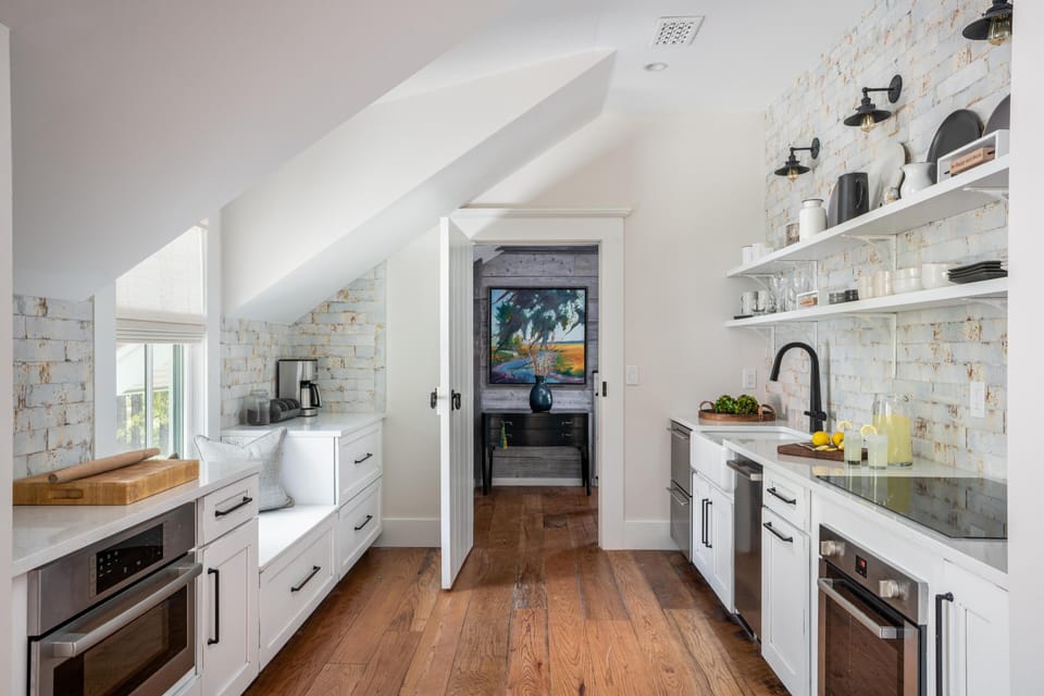 Full kitchen with oven, cooktop, dishwasher, and microwave.