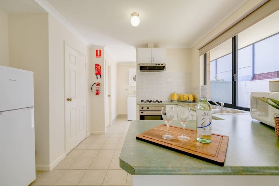 The kitchen is equipped for all your cooking needs, and fitted with a fridge, stove, oven, microwave, kettle and toaster.
