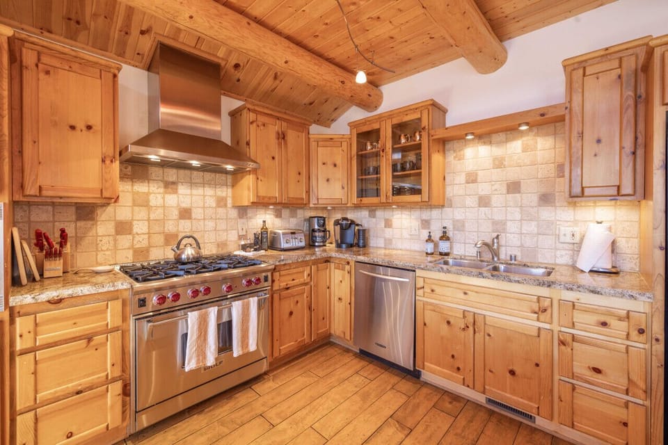 Upscale appliances with fully a fully stocked kitchen. Large oven and microwave below Stove