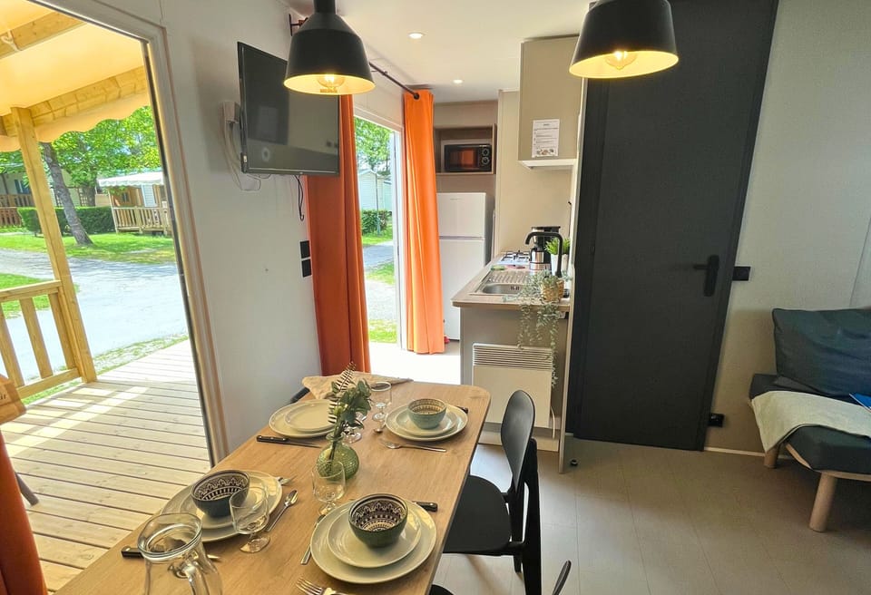 With a seamless flow to the outdoor deck, this dining space is ready for shared meals and lively conversations in a scenic and welcoming environment.