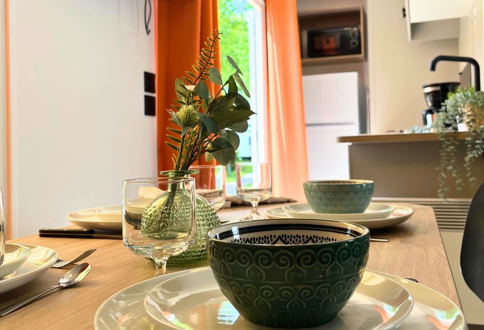 Set for a delightful meal, this dining area radiates warmth and charm, inviting guests to enjoy every bite in a cozy setting.