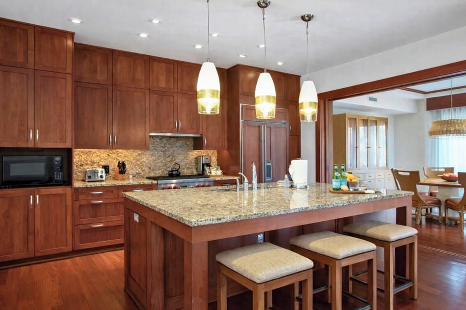 Rich wood cabinetry and granite counters define your kitchen, complete with bar seating for four and generous prep space.