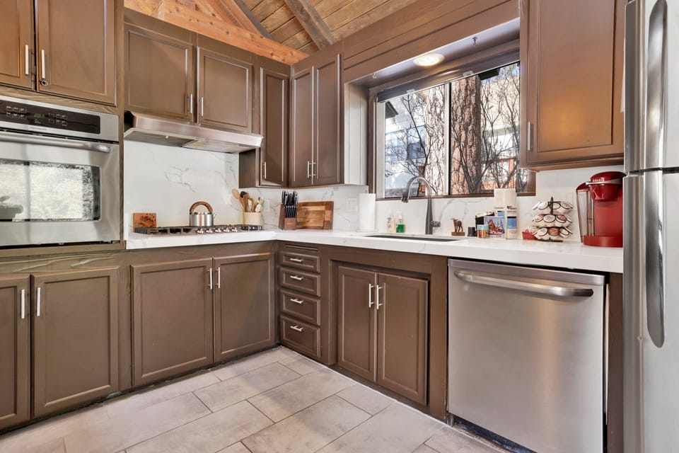 Fully equipped cabin kitchen with ample cabinetry, stove, fridge, microwave, and coffee maker—perfect for cooking meals, morning coffee, and feeling right at home on your stay.