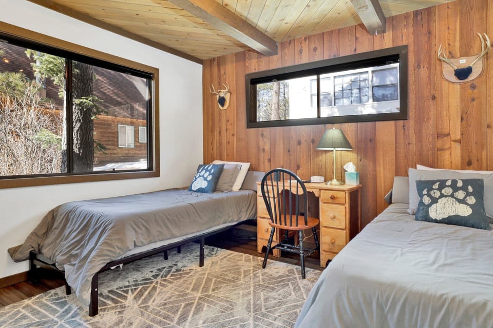 Peaceful cabin bedroom with plush bedding, and beautiful views—ideal for restful nights, cozy mornings, and a relaxing mountain escape.