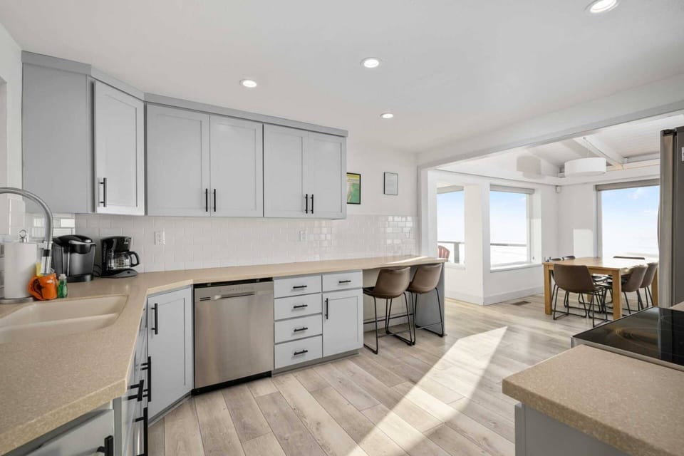 The open-layout kitchen features luxurious stainless steel appliances, making it a dream for cooking and gathering with loved ones.