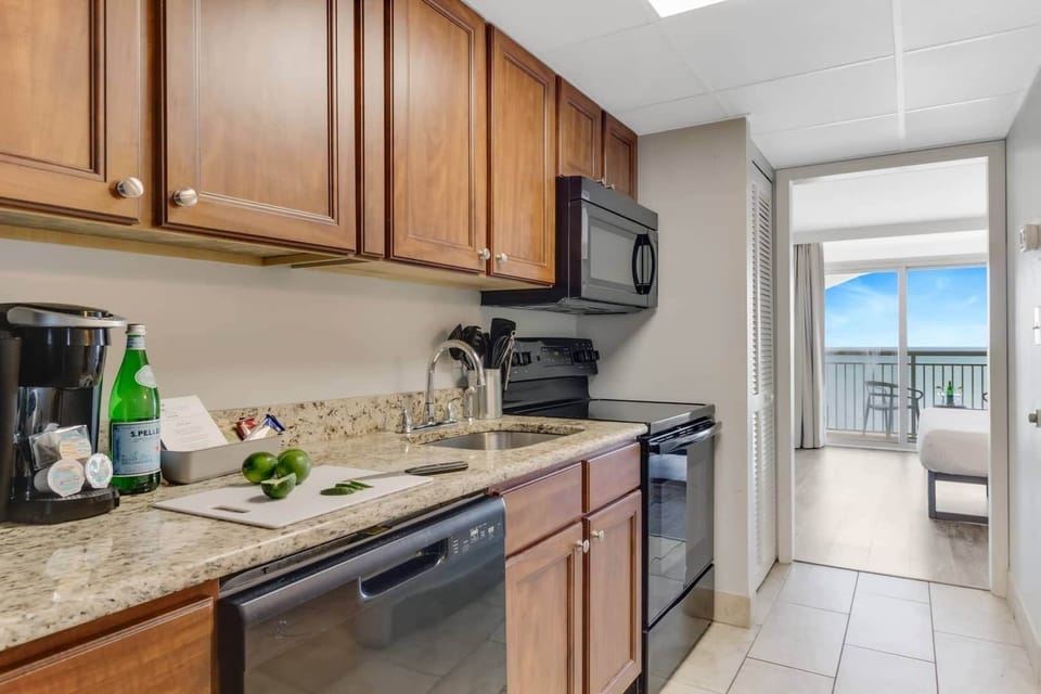Enjoy cooking in this fully equipped kitchen featuring modern appliances, sleek countertops, and a cozy dining area. Whether you're brewing a fresh cup of coffee or preparing a meal, this space offers convenience and style for your stay. 