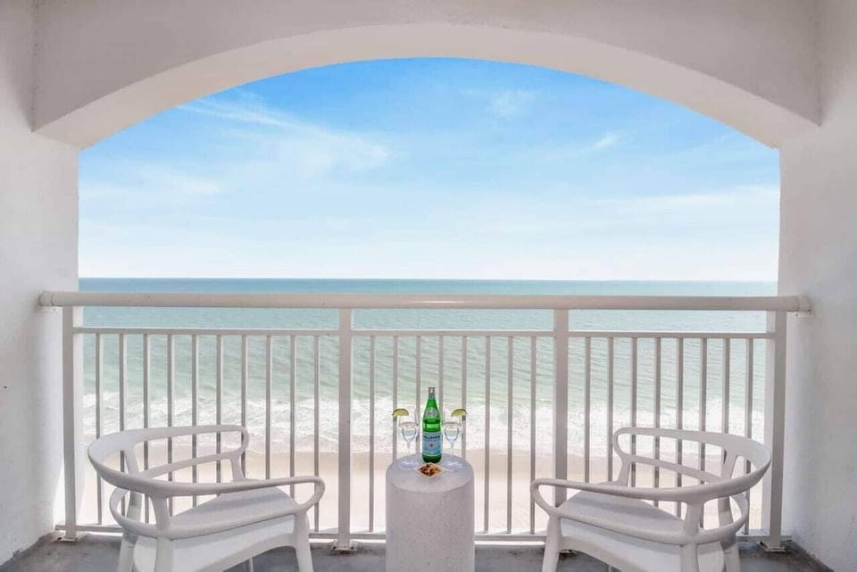 With comfortable seating and a side table perfect for snacks or drinks, this serene spot invites you to unwind and enjoy the gentle sea breeze and the calming sound of the waves.