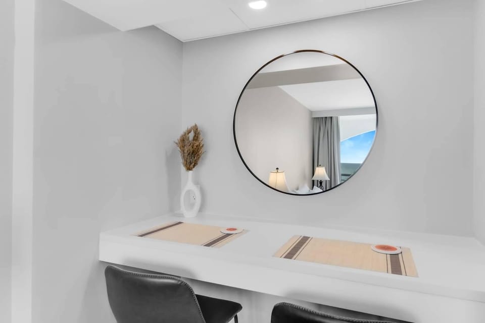 
Enjoy a peaceful moment at this sleek desk nook with a stylish mirror and modern décor. Perfect for a quiet breakfast or catching up on emails, this space blends function and design to enhance your stay.