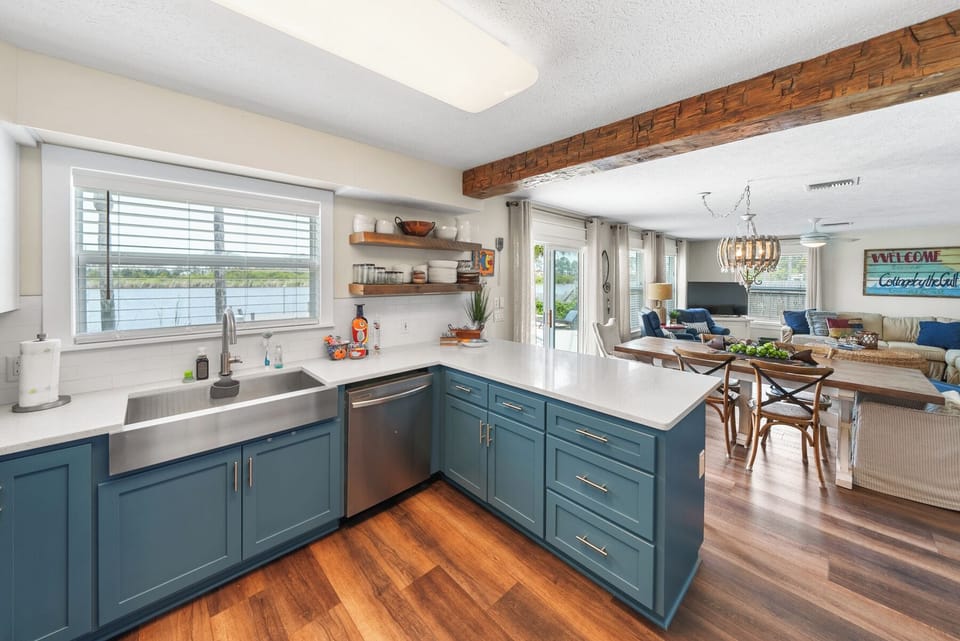 Your bright, modern kitchen features beautiful blue cabinets and flows seamlessly into the cozy living space—perfect for cooking and gathering together.
