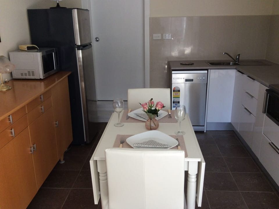 Dining table for two which can extend to seat four people
