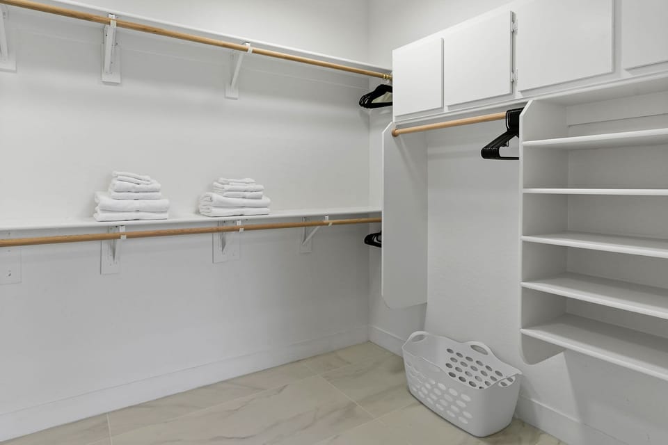 Primary ensuite standing tub, walk-in shower, walk-in closet, and private toilet