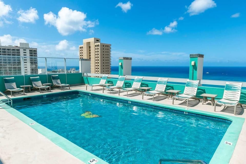 Slip into sparkling rooftop waters with endless ocean views.