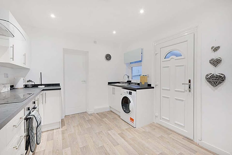Kitchen equipped with all essentials, including a washer & dryer, oven, fridge and full cookware set.