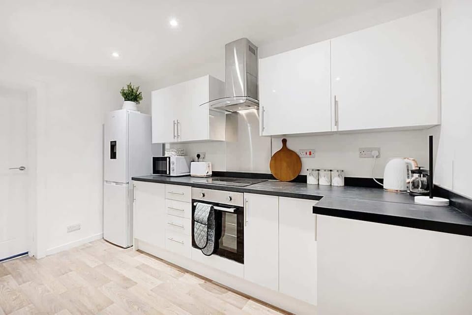 Kitchen equipped with all essentials, including a washer & dryer, oven, fridge and full cookware set.