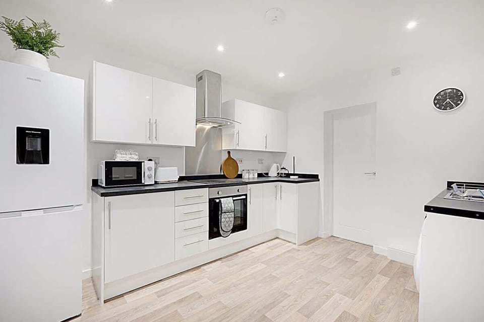 Kitchen equipped with all essentials, including a washer & dryer, oven, fridge and full cookware set.