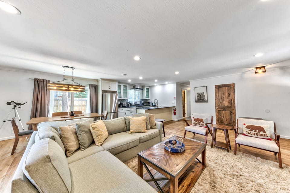 Unwind in this spacious open-concept living area where modern comfort meets rustic charm, perfect for your group gatherings.