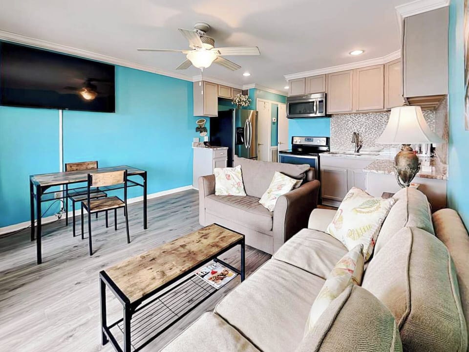 Living Area w. Plush Seating, Smart TV & Balcony Access