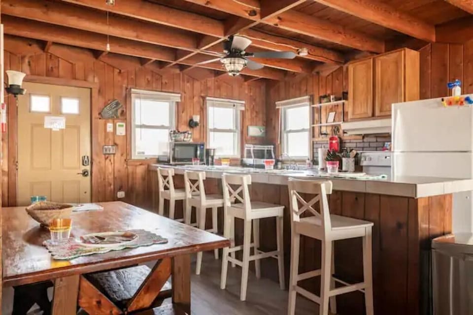 Long island accomodates four bar stools and additional seating at the table