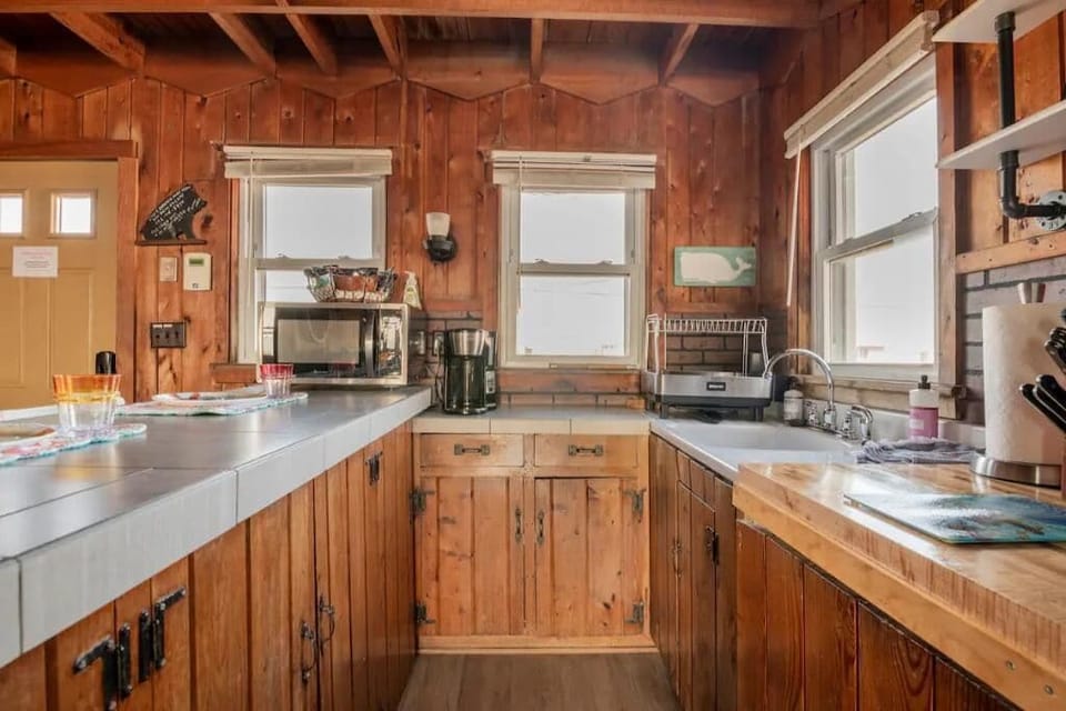 Microwave, coffee maker, dish drainer, NO DISHWASHER, sink and oven/stove.