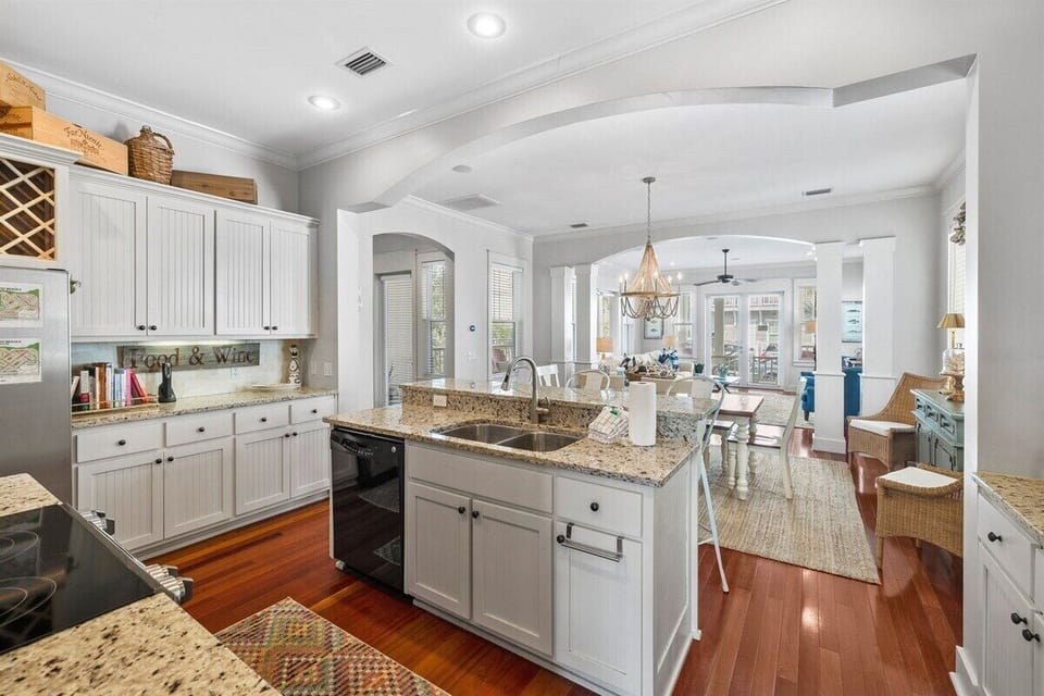 Kitchen overlooking dining room and living room. Backyard access is right behind the kitchen.