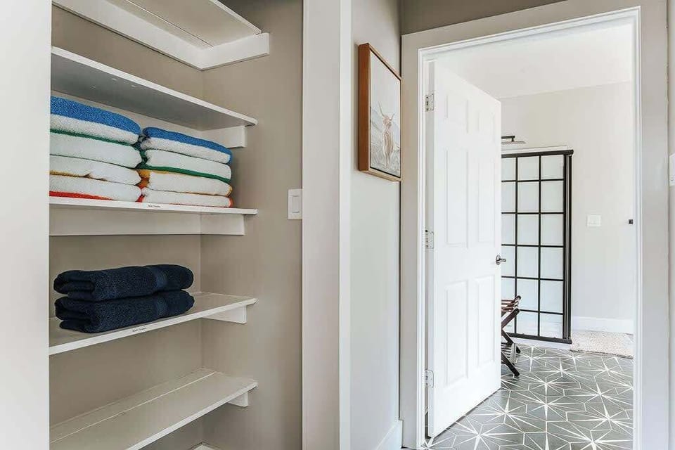 Linen closet stocked with extra towels and bedding as needed.