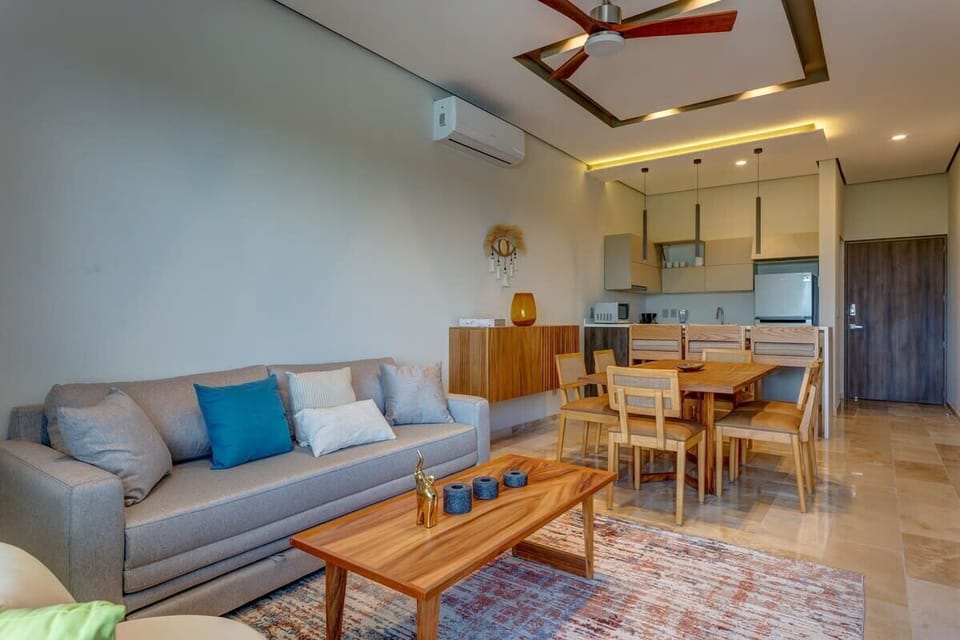 Relaxed living area with plush sofa and kitchen.