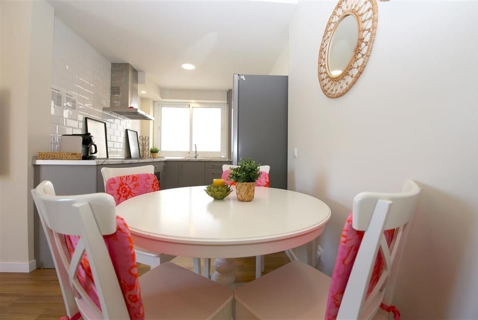 Dining table for four guests located on a side of the lounge area