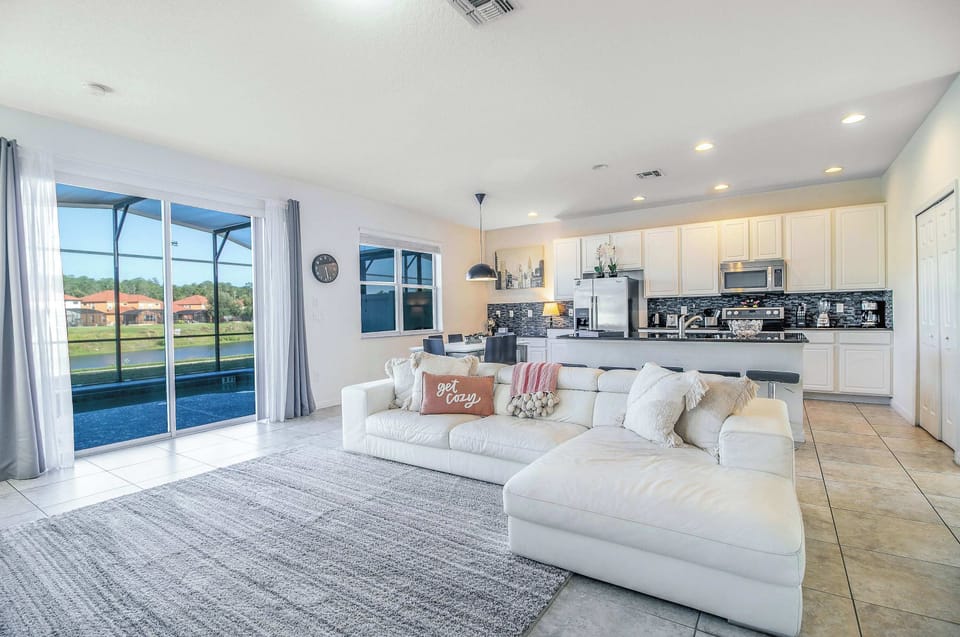 Bright and open living space with plush seating and lake views.