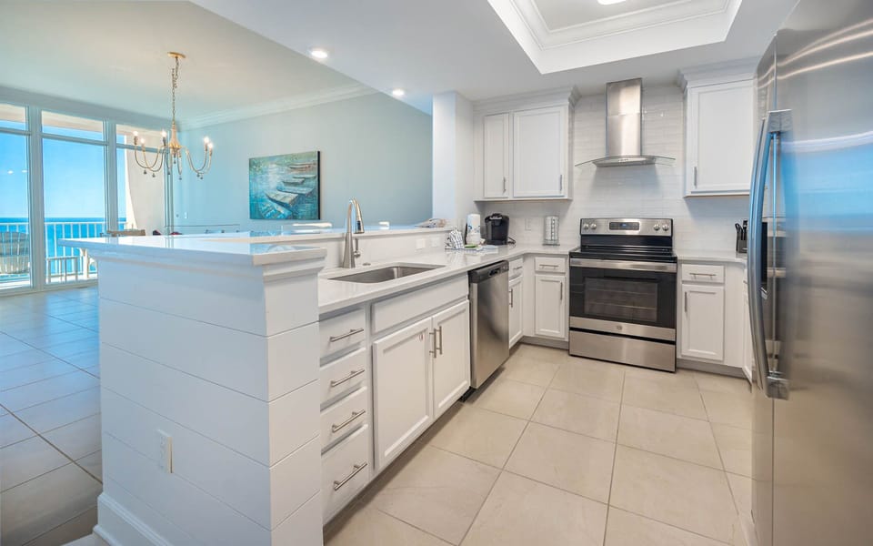 Prepare meals in this kitchen with elegant cabinetry, stainless appliances, and spacious countertops